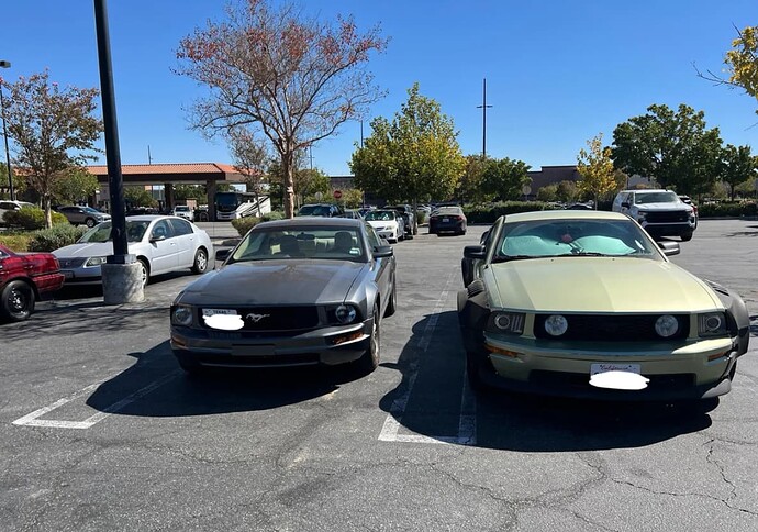 An image of many cars parked in a lot